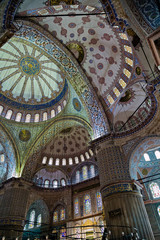 Fototapeta na wymiar Hand-painted blue tiles adorn the mosque interior walls