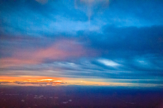 Dusk sky and cloud at morning dawn background. Vibrant colors of the sky with clouds from dusk till dawn. Dramatic evening cloudscape in the city. Twilight sky began to change from blue to orange.