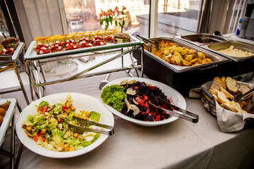 bruschetta on grilled bread with soft cheese and vegetable ratatouille, quiche loren and mini burger with veal pastry, cheese, mustard sauce at catering event on some festive event, party or wedding