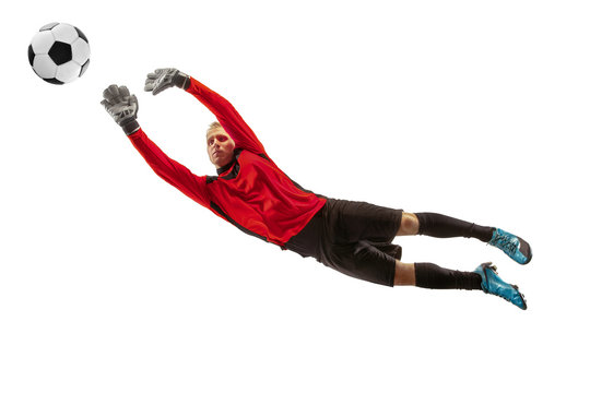 Male soccer player goalkeeper catching ball in jump. Silhouette of fit man with ball isolated on white studio background