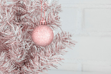 New Year background - golden New Year tree in loft interior. Closeup, Copy space. Pink.