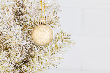 New Year background - golden New Year tree in loft interior. Closeup, Copy space.