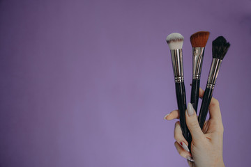 Make up brushes on purple background