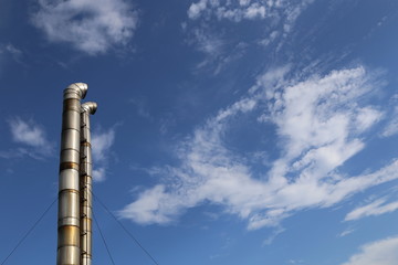 chimney under cloudy blue sky.