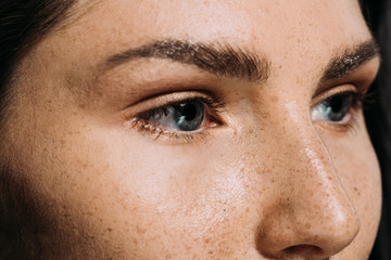 close up view of beautiful girl with freckles on face