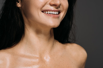 cropped view of smiling naked girl isolated on grey © LIGHTFIELD STUDIOS