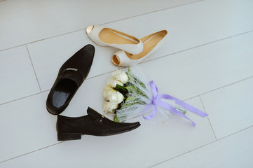 wedding shoes and bouquet of purple calla lilies