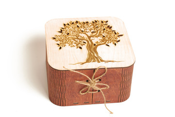 box with wooden lacing, with a tree on the lid, on a white background