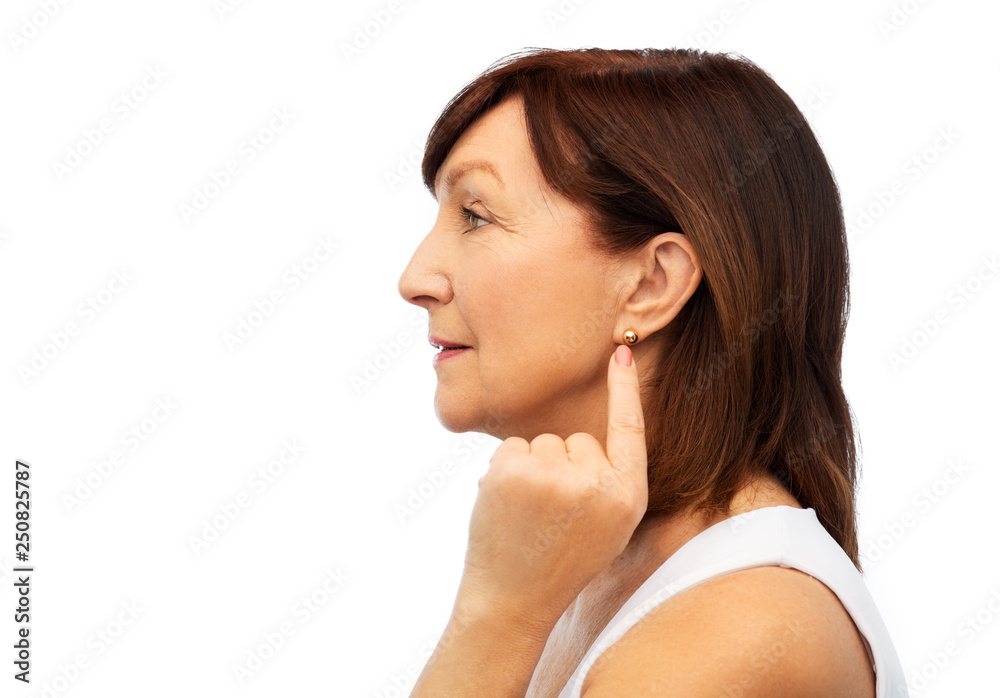 Sticker beauty and old people concept - profile of senior woman pointing to her golden earring over white