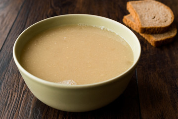 Wheat Soup with Chicken Broth Bouillon on Dark Wooden Surface.
