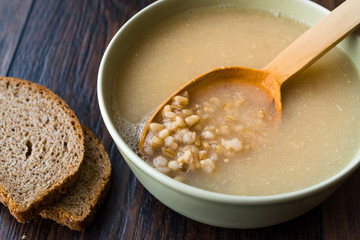 Wheat Soup with Chicken Broth Bouillon on Dark Wooden Surface.