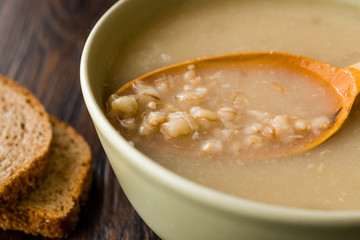 Wheat Soup with Chicken Broth Bouillon on Dark Wooden Surface.