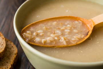 Wheat Soup with Chicken Broth Bouillon on Dark Wooden Surface.