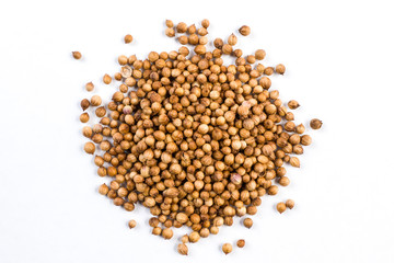 heap of coriander seeds isolated on white background. top view