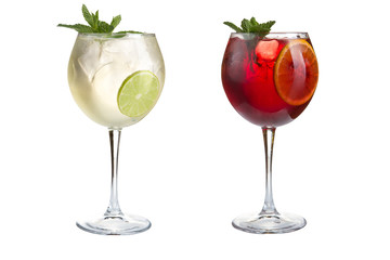 Two delicious turkey cocktails with mint, fruit and berries on a white background. Cocktails in glass goblets.