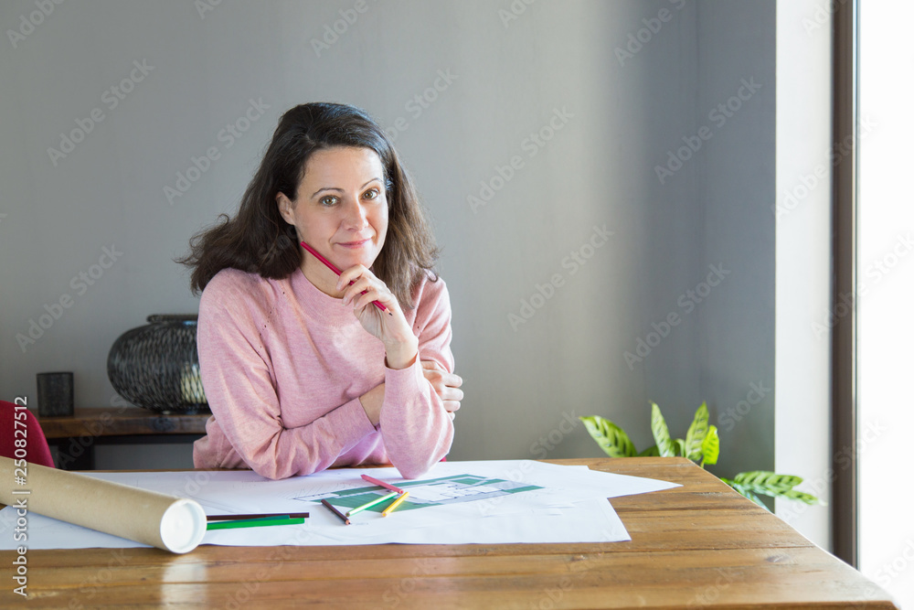 Wall mural smiling pensive interior designer thinking over renovation plan