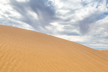 Fototapeta na wymiar Cloudscape over the Imperial Sand Dunes in California