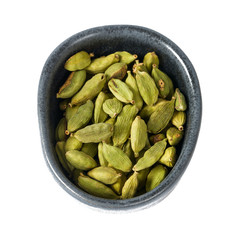 cardamom pods in a black bowl