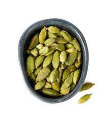 cardamom pods in a black bowl