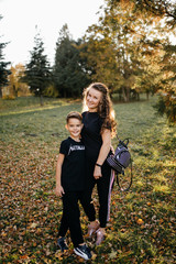 Smiling woman wearing sports clothes ready for training outdoors with  son