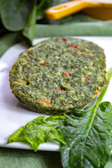 Healthy vegetarian or vegan food, uncooked green spinach burgers, ingredient for hamburgers