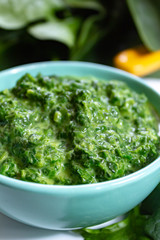 Healthy vegetarian or vegan food, cooked green spinach with cream, ingredient for many dishes like pasta, ravioli or soup