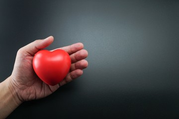 Man Hand holding Red Heart,Concept of Love and Health care,family insurance.World heart day, World...