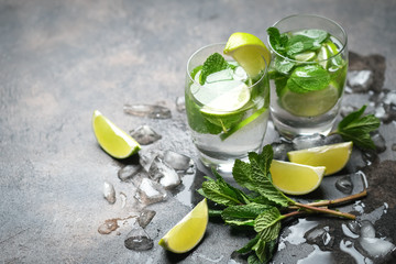 Mojito cocktail with ice, mint and lime on a dark background top view.