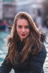 fashionable portrait of young beautiful woman in a European city on a sunny winter day