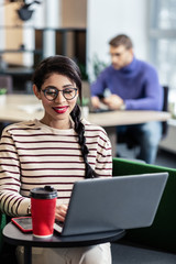 Cute longhaired brunette girl working with pleasure