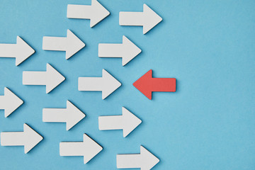 top view of red horizontal pointer opposite white arrows on blue background