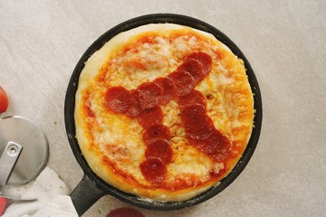 Pi day pepperoni Pizza overhead view