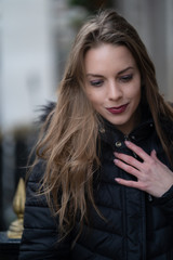 fashionable portrait of young beautiful woman in a European city on a sunny winter day