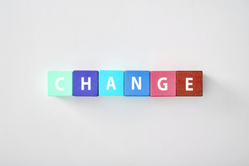 Obraz premium top view of change lettering made of multicolored cubes on grey background