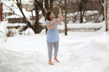 kid pounded with snow and playing barefoot in snow