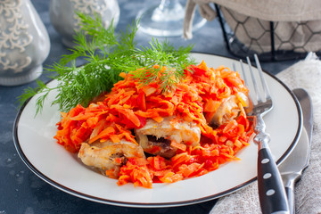 Polished marinated carrots and onionson a white plate, horizontal