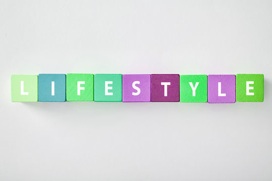 top view of lifestyle lettering made of multicolored blocks on grey background