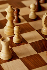 selective focus of wooden chess pieces on chess board