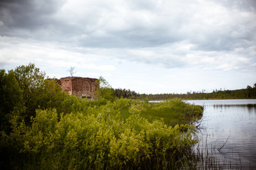 Fototapeta premium ruins of an old building. church near the lake
