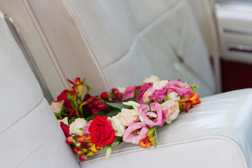 a bouquet on the car seat in a bright interior