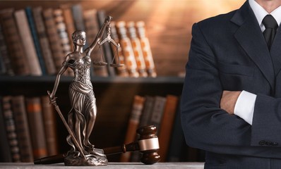 Lawyer standing with crossed arms, Scales of Justice on the background