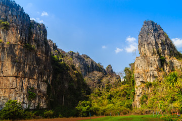 Landscape view of farmer hut in the rice field after harvested with limestone mountains range and blue sky background at Ban Mung village, Noen Maprang district, Phitsanulok province, Thailand.