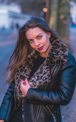 fashionable portrait of young beautiful woman in a European city on a sunny winter day