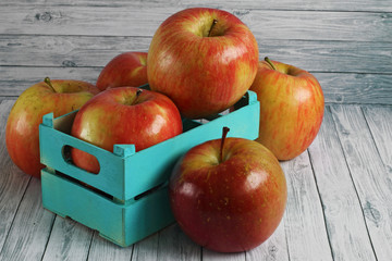 Red apples on white wooden background