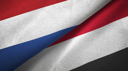 Fototapeta na wymiar Netherlands and Yemen two flags textile cloth, fabric texture