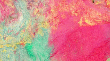 Colorful sparkling paints mix in beautiful patterns. Oil ink of crimson, green, yellow, red and other colors spread on the surface and mix one into another creating amazing textures and design.