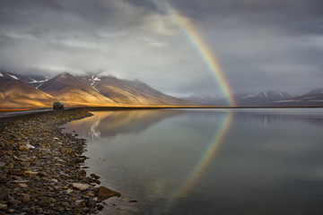 Arctic landscape with rainbow after rain in Svalbard during autumn. Norway