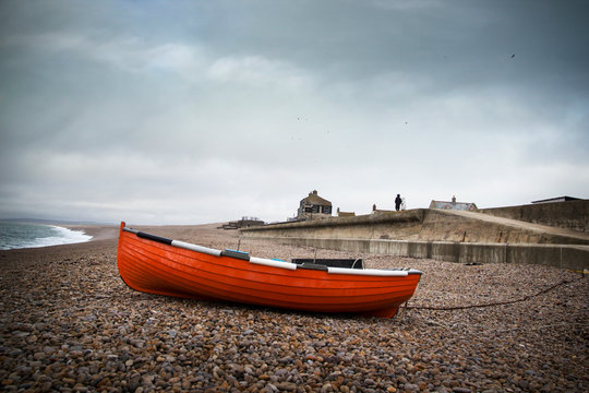 Dark skies over Chesil famous for its pebble beach in Weymouth, a coastal town in the county of Dorset, England, UK.