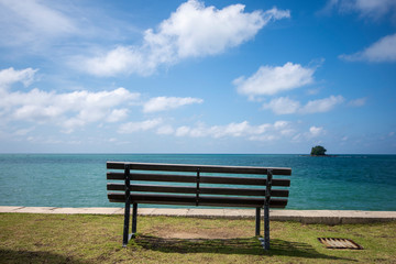 Fototapeta na wymiar Wooden bench in front of the sea