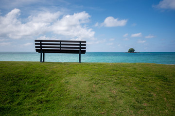 Wooden bench in front of the sea